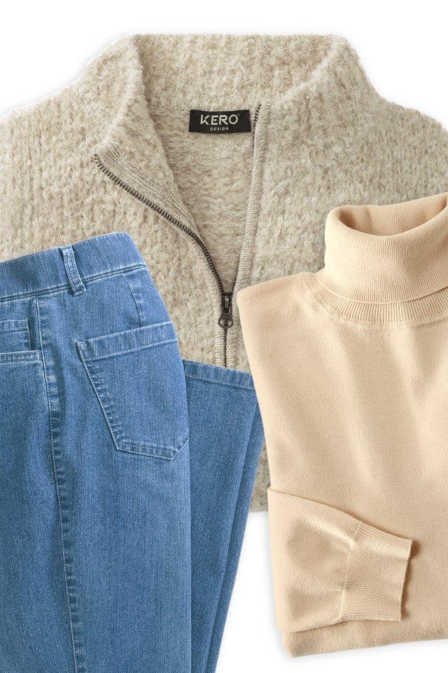Outfti-Vorschlag bestehend aus einer kuscheligen Alpaka-Strickjacke, einem beigefarbenen Rollkragenpullover und einer blauen Jeans.