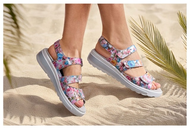 Die Semler-Sandalen Komfortplus werden am Strand getragen und haben ein buntes florales Muster.