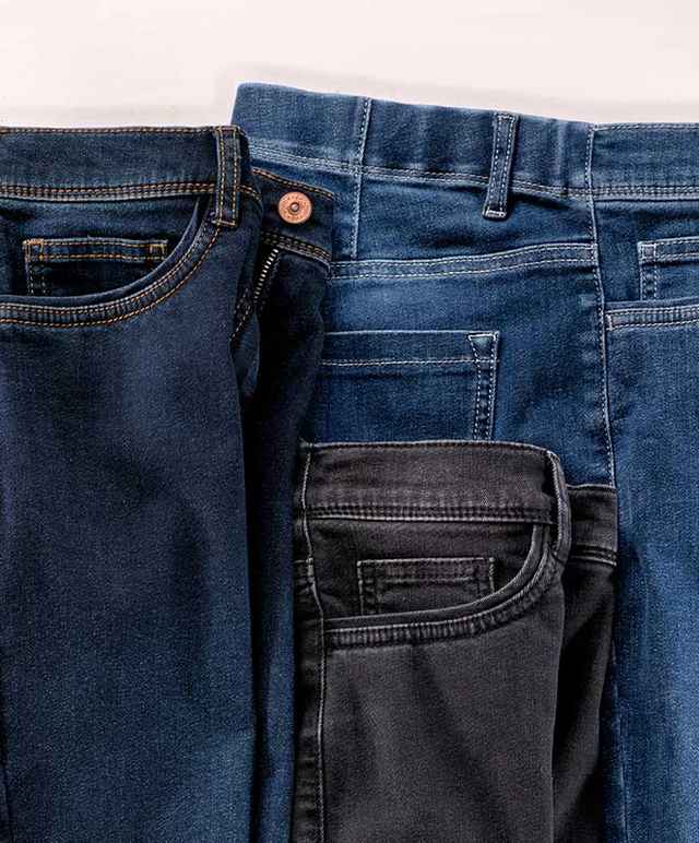 Drei Paar Jeans in unterschiedlichen Blautönen und Schwarz sind nebeneinander aufgereiht.